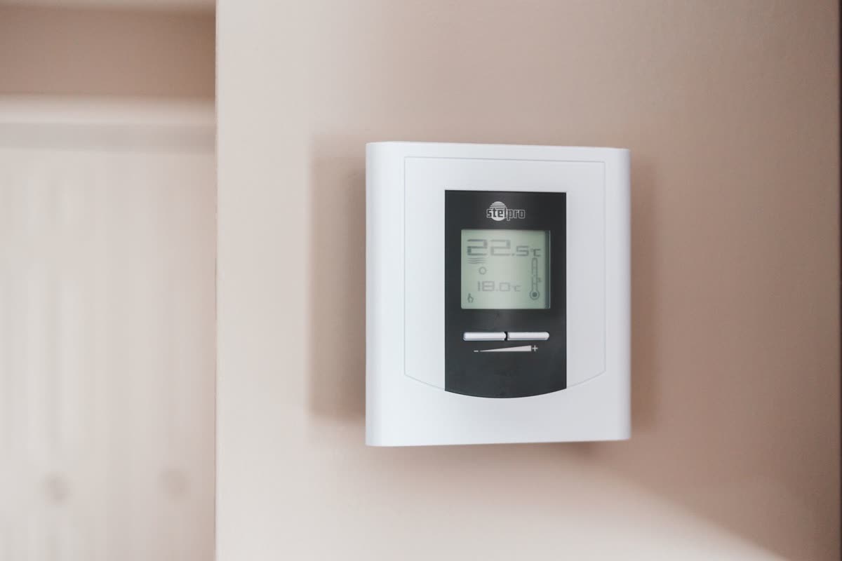 A wall mounted heating thermostat in a Plymouth home
