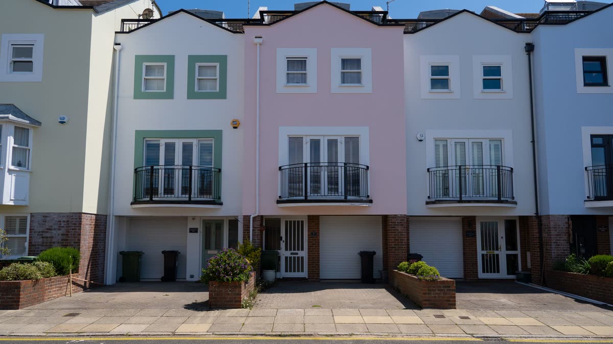 A row of pastel painted terraced houses on the south coast
